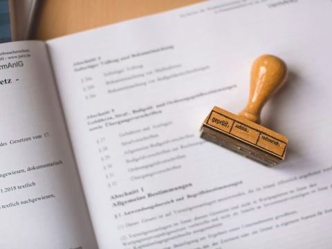 A rubber stamp resting on an open legal document