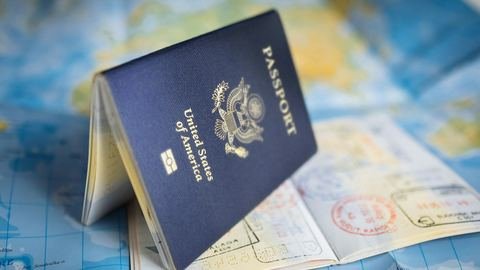 A United States passport standing open on a world map